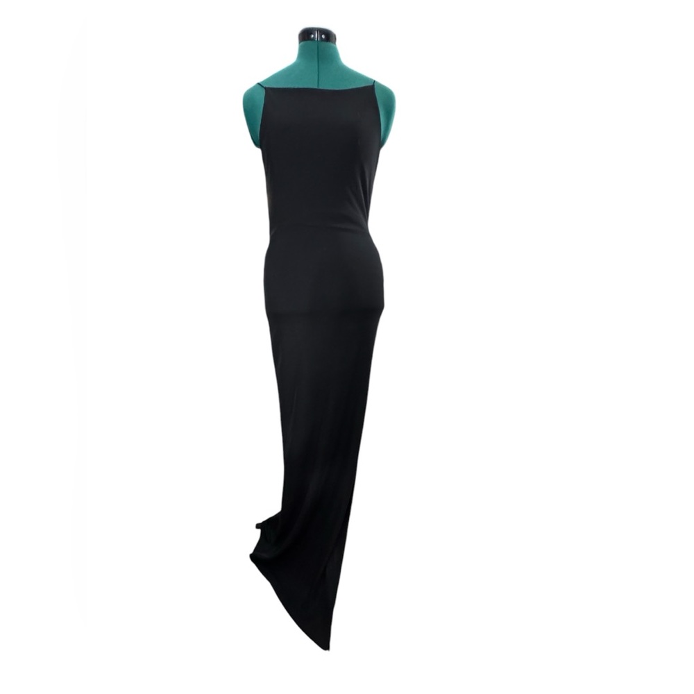 Long black strappy dress with a minimalist design. Slim fit that highlights